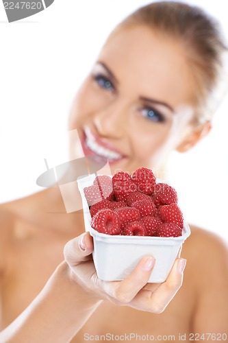 Image of Close up of smiling blonde holding raspberries