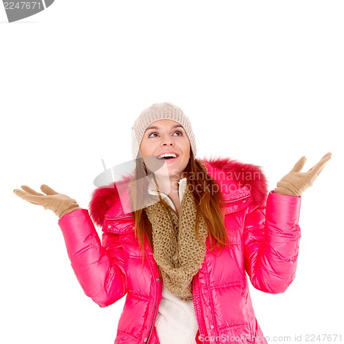 Image of Young woman wearing winter jacket scarf and cap