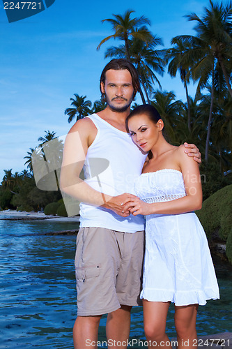 Image of Couple next to Palm tree