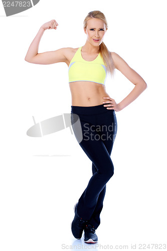 Image of Sporty blond girl showing her muscles
