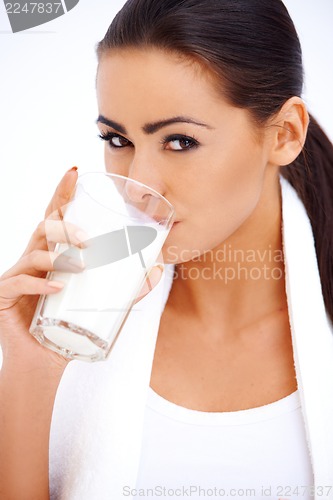 Image of Woman is drinking milk from a glass