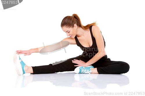 Image of Beautiful fitness woman doing stretching exercise