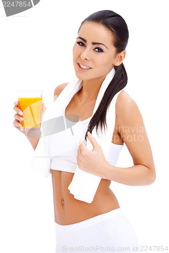 Image of Woman holding glass of fresh orange juice