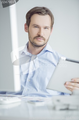 Image of Attractive male sitting at his desk