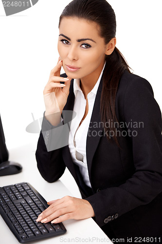 Image of Woman in black suit sitting in front of computer