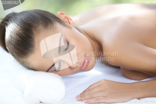 Image of Beautiful woman is resting on spa bed