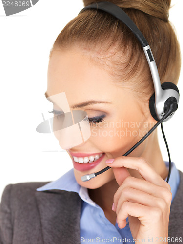 Image of Pretty female businesswoman talking headset