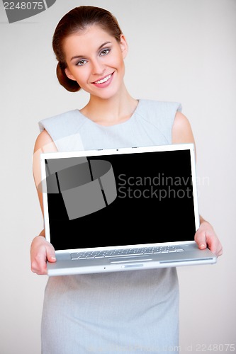 Image of Young attractive business woman with laptop computer