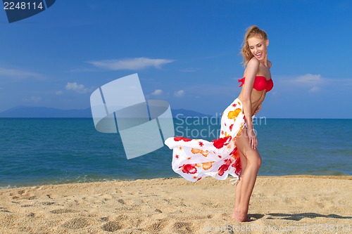 Image of Playful moment with a pretty blonde on the beach