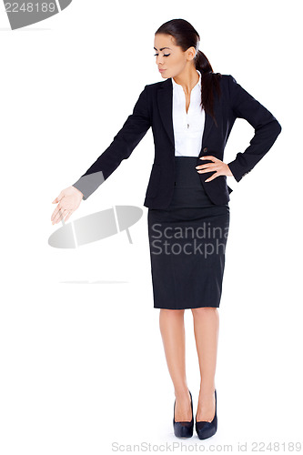 Image of Business woman standing and pointing at copy space