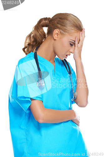 Image of Doctor holding her head in anguish
