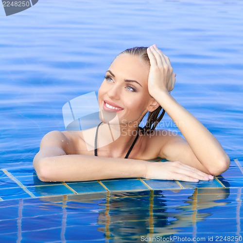 Image of Smiling Woman Reflected In Pool