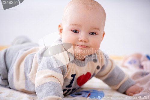 Image of Contented little baby smiling at the camera