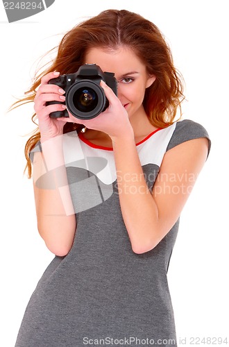 Image of Woman in gray dress wit digtal camera on white