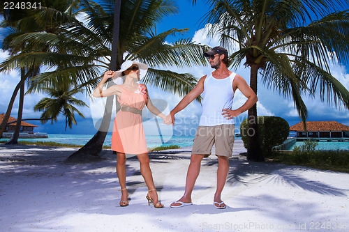 Image of Couple nex to Palm tree