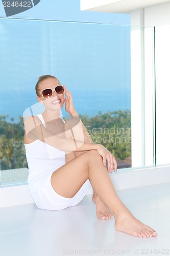 Image of Sensual woman sitting at balcony with a view