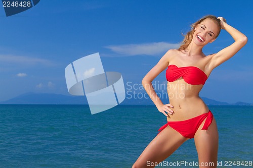 Image of Beautiful smiling woman ,  blue sea and sky