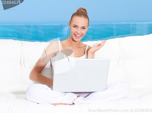 Image of Woman on canopied seat with laptop