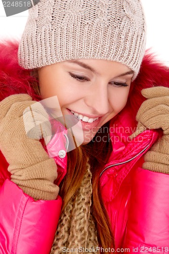 Image of Young woman wearing winter jacket scarf and cap