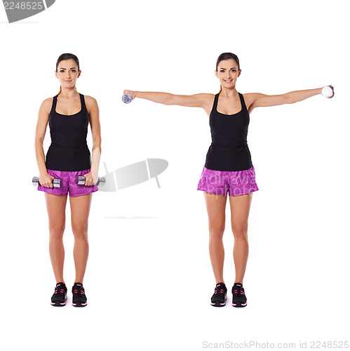 Image of Young woman working out with dumbbells