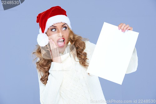 Image of Blond woman in Santa Hat is in hudge shock