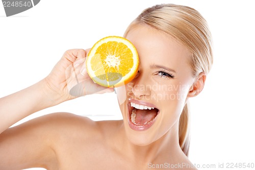 Image of Blond woman with beautiful smile holding orange