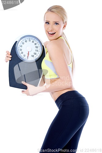 Image of Smiling woman holding a waight scale