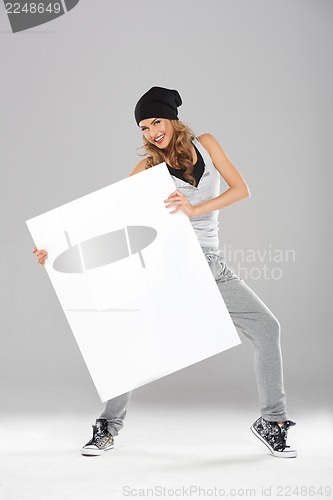 Image of Young fashionable modern dancer holding empty board