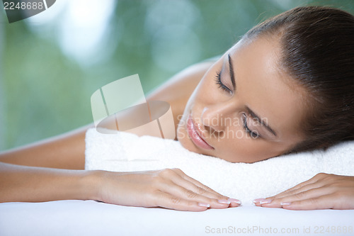 Image of Beautiful woman is resting on spa bed