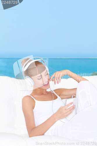 Image of Cute woman listening to music