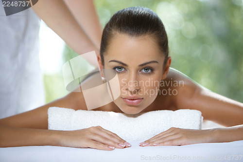 Image of Beautiful woman is resting on spa bed