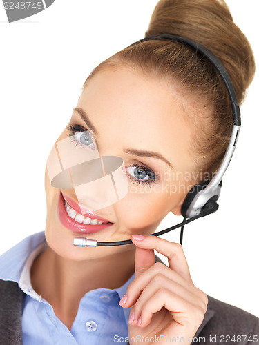 Image of Pretty female businesswoman talking headset