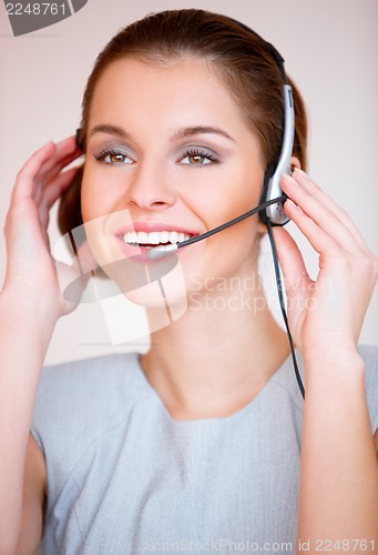 Image of Young attractive business woman with headset