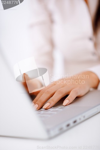 Image of Business woman typing on laptop keyboard