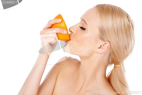 Image of Blond woman with beautiful smile holding orange