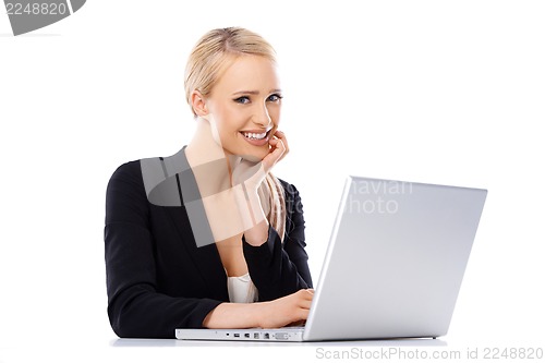 Image of Cute blond business woman working on laptop