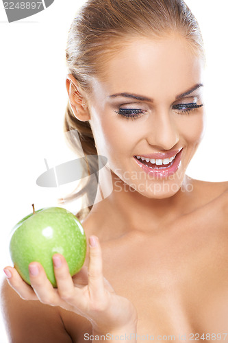 Image of Happy woman with a crisp green apple