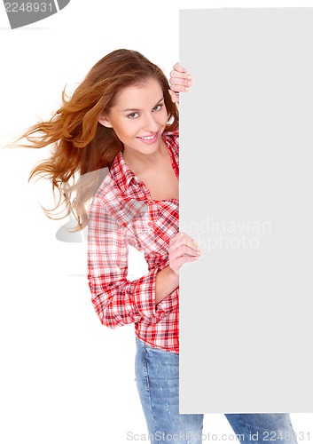 Image of Young woman in casual clothing holding empty board