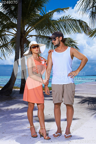 Image of Couple nex to Palm tree