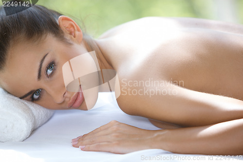 Image of Beautiful woman is resting on spa bed