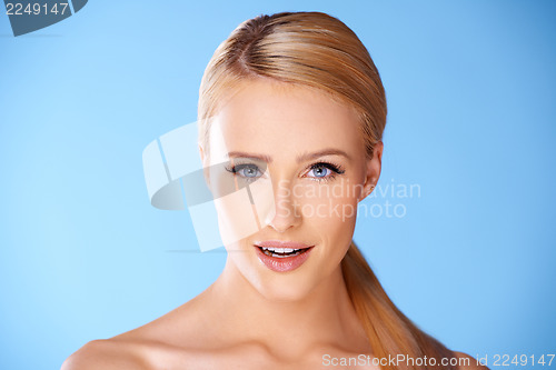 Image of Close up portrait of blond woman on blue