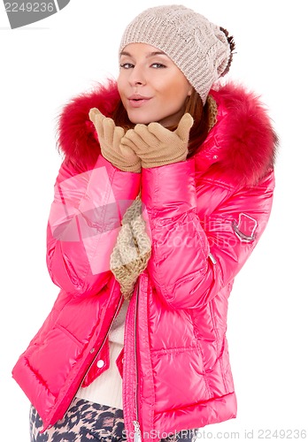 Image of Young woman wearing winter jacket scarf and cap