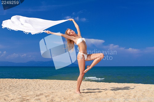 Image of Bikini clad beauty in a dancers pose at the beach