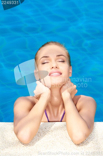 Image of Dreaming woman in swimming pool