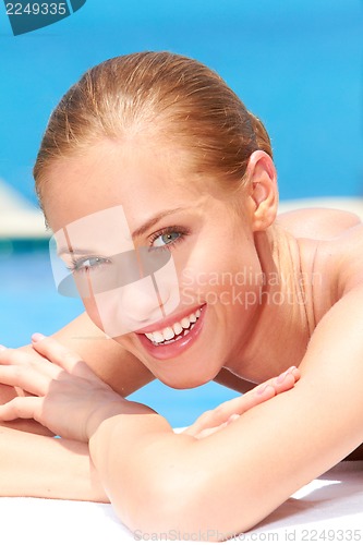 Image of Beauty lying next to swimming pool