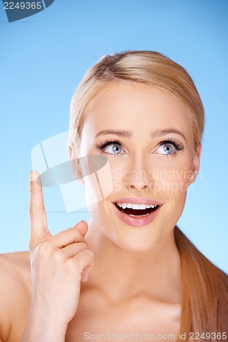 Image of Blond beautiful woman on blue
