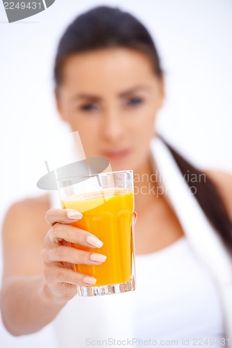 Image of Woman holding glass of fresh orange juice