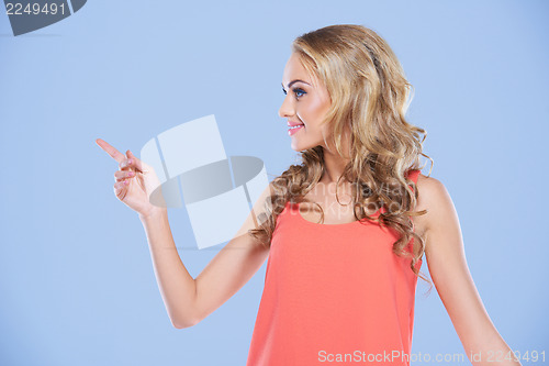 Image of Woman pointing to the left of the frame