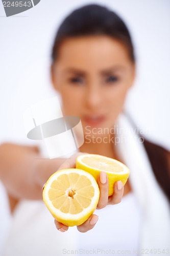 Image of Close up of a woman showing fresh lemon