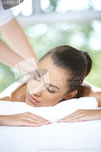 Image of Beautiful woman is resting on spa bed